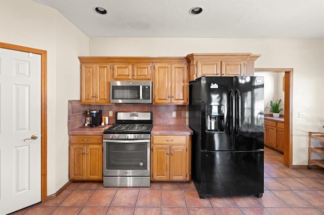 125 NW 147th St, Edmond, OK 73013 - kitchen featuring appliances with stainless steel finishes, backsplash, and tile patterned floors