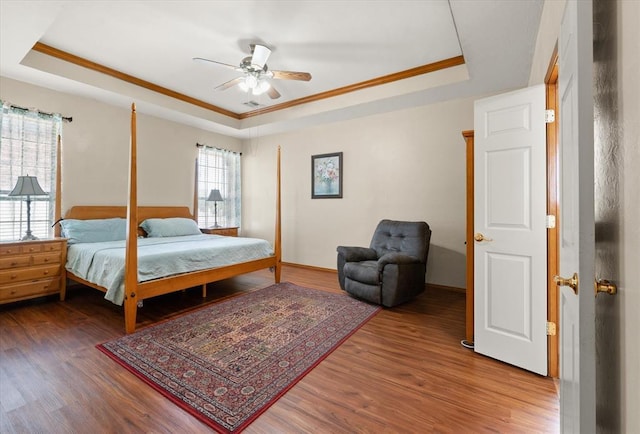 125 NW 147th St, Edmond, OK 73013 - bedroom featuring a tray ceiling, wood finished floors, crown molding, and a ceiling fan
