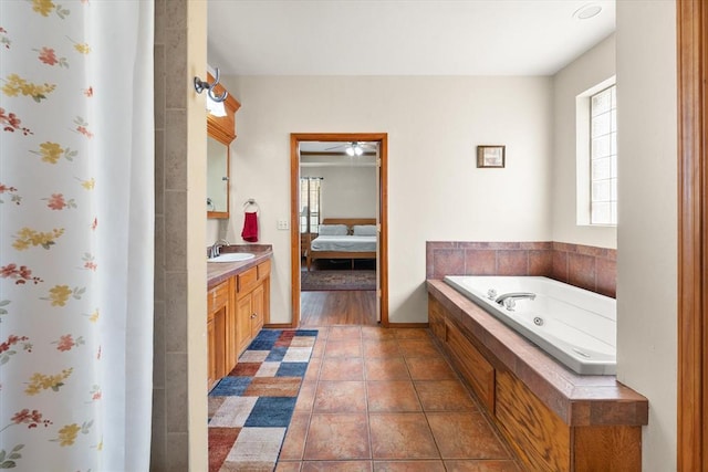 125 NW 147th St, Edmond, OK 73013 - ensuite bathroom featuring healthy amount of natural light, vanity, a whirlpool tub, and a shower with curtain