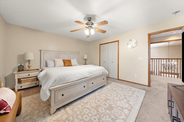 125 NW 147th St, Edmond, OK 73013 - bedroom featuring light colored carpet, a chandelier, a closet, and ceiling fan