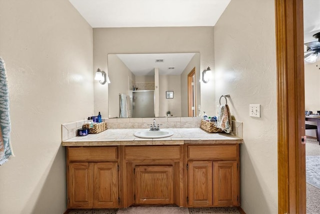 125 NW 147th St, Edmond, OK 73013 - full bathroom with vanity, a shower with door, and a textured wall