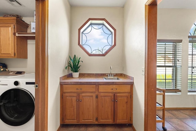 125 NW 147th St, Edmond, OK 73013 - laundry area with washer / clothes dryer, cabinet space, and healthy amount of natural light