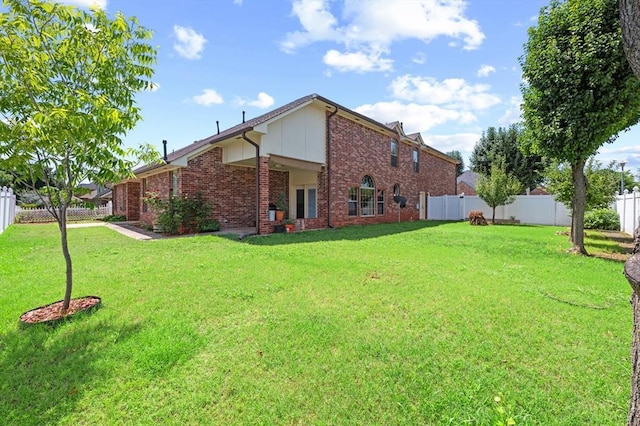 125 NW 147th St, Edmond, OK 73013 - rear view of house with brick siding and a fenced backyard