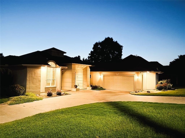 1004 Reginald Dr, Norman, OK 73072 - ranch-style house featuring driveway, an attached garage, a front yard, and stucco siding
