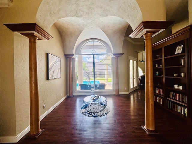 1004 Reginald Dr, Norman, OK 73072 - hall with decorative columns, a textured wall, wood finished floors, and arched walkways