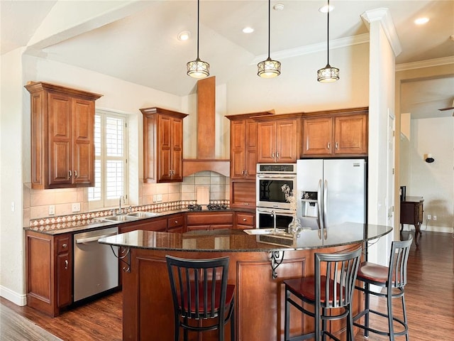 1004 Reginald Dr, Norman, OK 73072 - kitchen with appliances with stainless steel finishes, dark wood finished floors, decorative backsplash, a breakfast bar area, and vaulted ceiling
