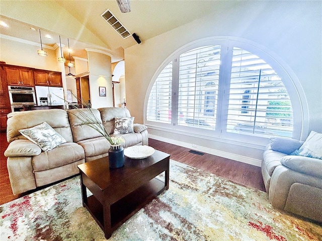 1004 Reginald Dr, Norman, OK 73072 - living area featuring wood finished floors, vaulted ceiling, and recessed lighting