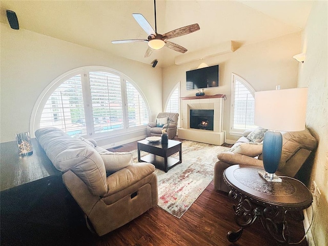 1004 Reginald Dr, Norman, OK 73072 - living room with wood finished floors, ceiling fan, lofted ceiling, and a tile fireplace