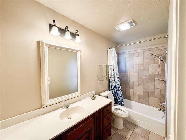 1004 Reginald Dr, Norman, OK 73072 - bathroom featuring vanity, tile patterned floors, shower / bath combination with curtain, and a textured ceiling