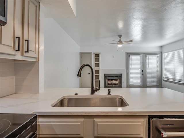 11550 N May Ave Unit 108, Oklahoma City, OK 73120 - kitchen with dishwashing machine, ceiling fan, backsplash, light stone countertops, and open floor plan