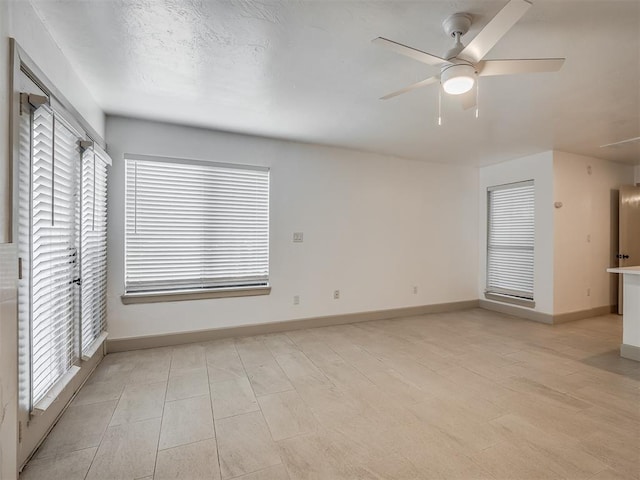 11550 N May Ave Unit 108, Oklahoma City, OK 73120 - unfurnished living room with a ceiling fan and baseboards