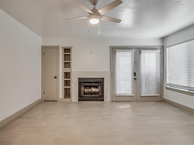 11550 N May Ave Unit 108, Oklahoma City, OK 73120 - unfurnished living room with ceiling fan, a premium fireplace, and french doors