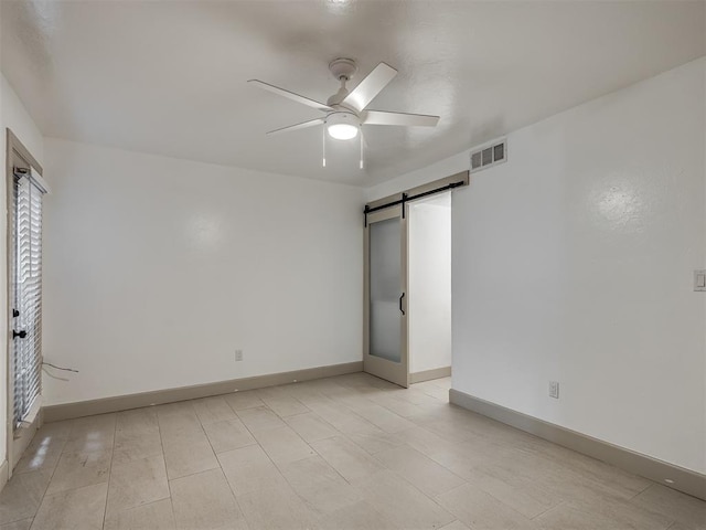 11550 N May Ave Unit 108, Oklahoma City, OK 73120 - unfurnished bedroom with a barn door, a ceiling fan, and multiple windows