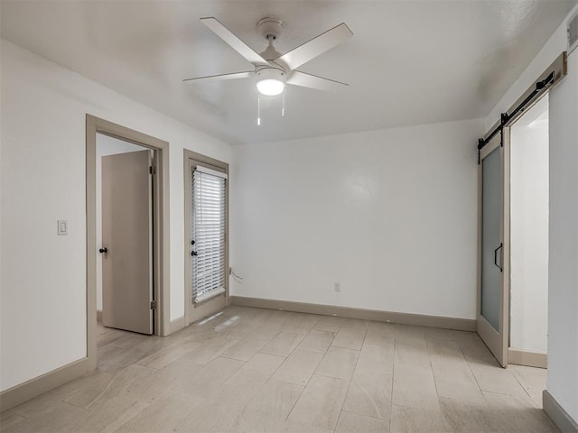 11550 N May Ave Unit 108, Oklahoma City, OK 73120 - unfurnished bedroom with a barn door and a ceiling fan
