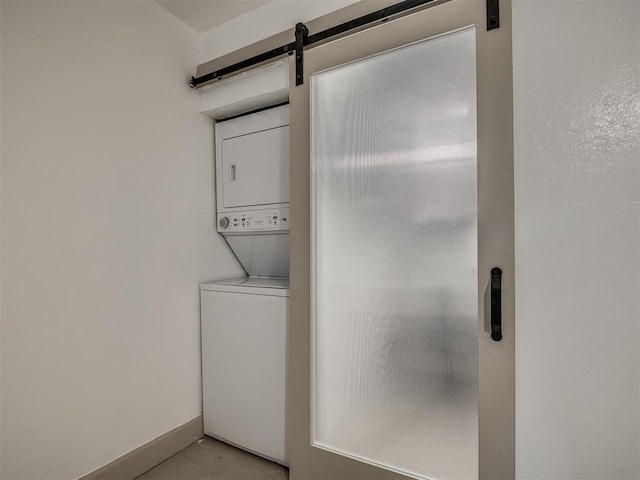 11550 N May Ave Unit 108, Oklahoma City, OK 73120 - laundry room with stacked washer / drying machine and a barn door