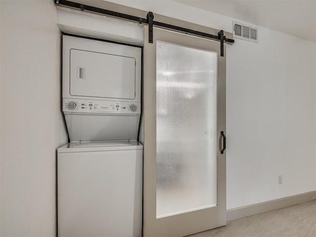 11550 N May Ave Unit 108, Oklahoma City, OK 73120 - laundry room with estacked washer and dryer and a barn door