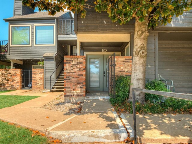 11550 N May Ave Unit 108, Oklahoma City, OK 73120 - entrance to property featuring a balcony and a chimney