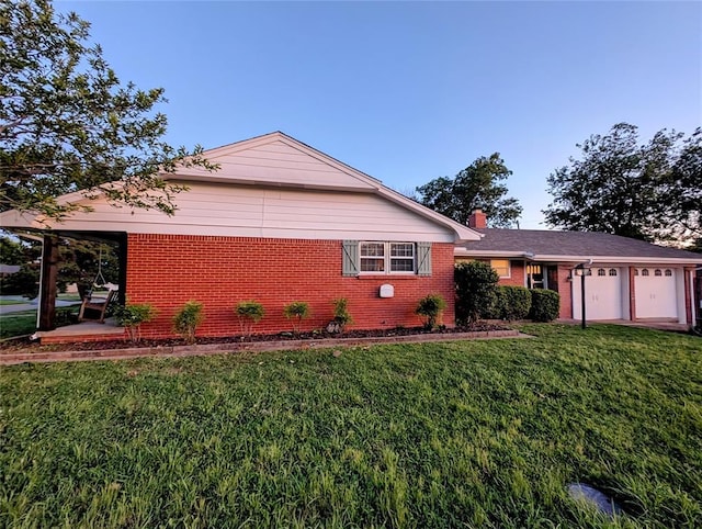 2436 NW 43rd Cir, Oklahoma City, OK 73112 - view of front facade with brick siding, a front yard, an attached garage, and a chimney