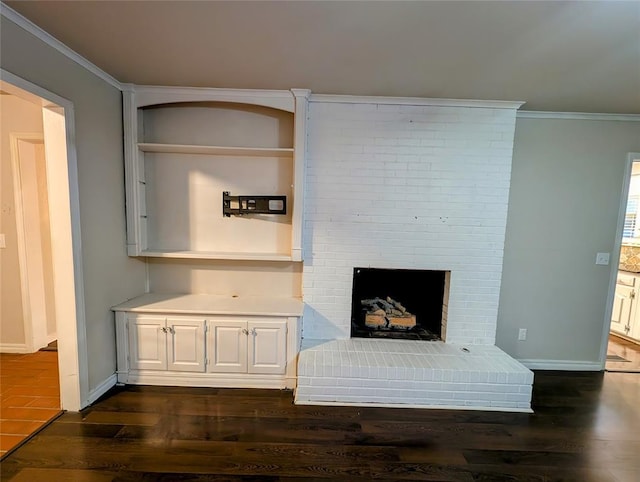2436 NW 43rd Cir, Oklahoma City, OK 73112 - unfurnished living room with ornamental molding, dark wood finished floors, and a brick fireplace