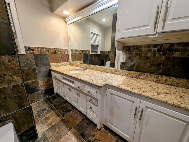 2436 NW 43rd Cir, Oklahoma City, OK 73112 - full bath with vanity, tile walls, stone tile floors, recessed lighting, and a wainscoted wall