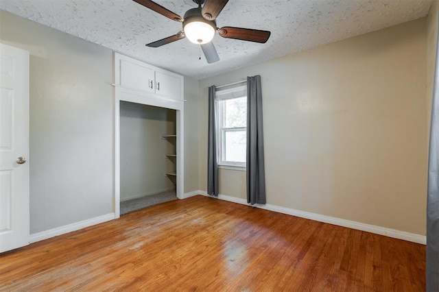 2204 Churchill Pl, Oklahoma City, OK 73120 - unfurnished bedroom featuring light wood-type flooring, a closet, ceiling fan, and a textured ceiling