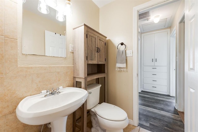 2204 Churchill Pl, Oklahoma City, OK 73120 - half bathroom with tile walls and wood finished floors