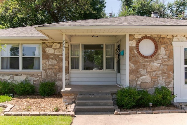 2204 Churchill Pl, Oklahoma City, OK 73120 - property entrance featuring stone siding and a shingled roof