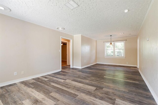 2204 Churchill Pl, Oklahoma City, OK 73120 - unfurnished room with a textured ceiling and dark wood-type flooring