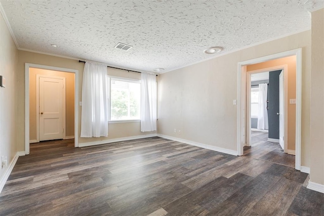 2204 Churchill Pl, Oklahoma City, OK 73120 - empty room featuring ornamental molding, dark wood-style floors, and a textured ceiling