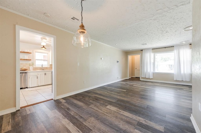 2204 Churchill Pl, Oklahoma City, OK 73120 - spare room featuring ornamental molding, wood finished floors, and a textured ceiling