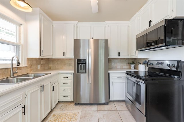 2204 Churchill Pl, Oklahoma City, OK 73120 - kitchen with appliances with stainless steel finishes, light countertops, white cabinetry, and light tile patterned floors
