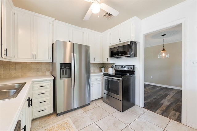 2204 Churchill Pl, Oklahoma City, OK 73120 - kitchen with stainless steel appliances, light countertops, ceiling fan, and white cabinetry