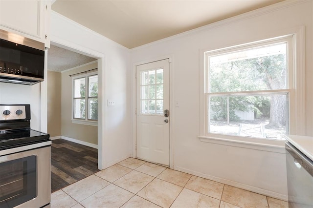 2204 Churchill Pl, Oklahoma City, OK 73120 - kitchen featuring stainless steel appliances, ornamental molding, white cabinetry, light countertops, and light tile patterned floors
