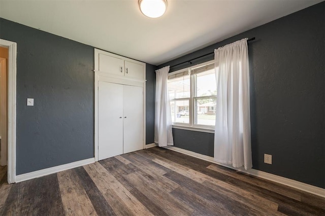 2204 Churchill Pl, Oklahoma City, OK 73120 - unfurnished bedroom with dark wood-style floors, a closet, and a textured wall