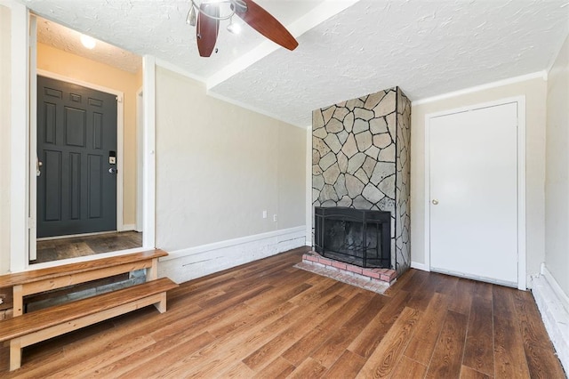 2204 Churchill Pl, Oklahoma City, OK 73120 - unfurnished living room featuring a textured ceiling, ceiling fan, wood finished floors, and a large fireplace