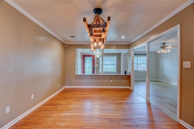 824 N Poplar Ln, Midwest City, OK 73130 - unfurnished room featuring wood finished floors, crown molding, ornate columns, and a chandelier