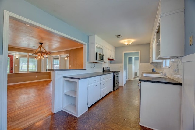 824 N Poplar Ln, Midwest City, OK 73130 - kitchen featuring stainless steel appliances, open shelves, dark countertops, and white cabinets
