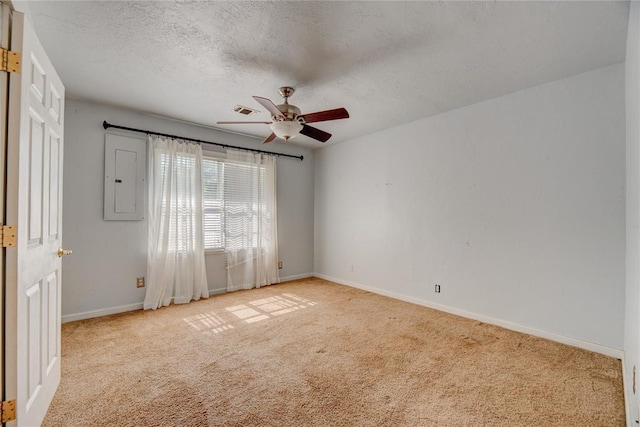824 N Poplar Ln, Midwest City, OK 73130 - spare room featuring light colored carpet, ceiling fan, electric panel, and a textured ceiling