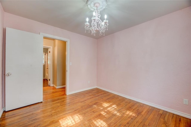 824 N Poplar Ln, Midwest City, OK 73130 - empty room featuring a chandelier and light wood-style floors