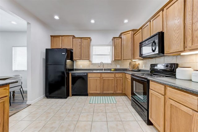 825 Elm Ave, Yukon, OK 73099 - kitchen featuring black appliances, dark countertops, backsplash, recessed lighting, and light tile patterned floors