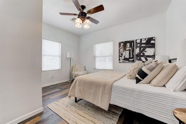 825 Elm Ave, Yukon, OK 73099 - bedroom with multiple windows, dark wood finished floors, and ceiling fan