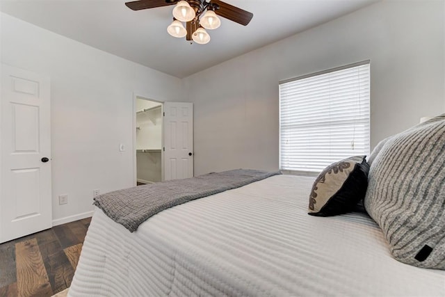 825 Elm Ave, Yukon, OK 73099 - bedroom with dark wood-type flooring, a ceiling fan, and a spacious closet