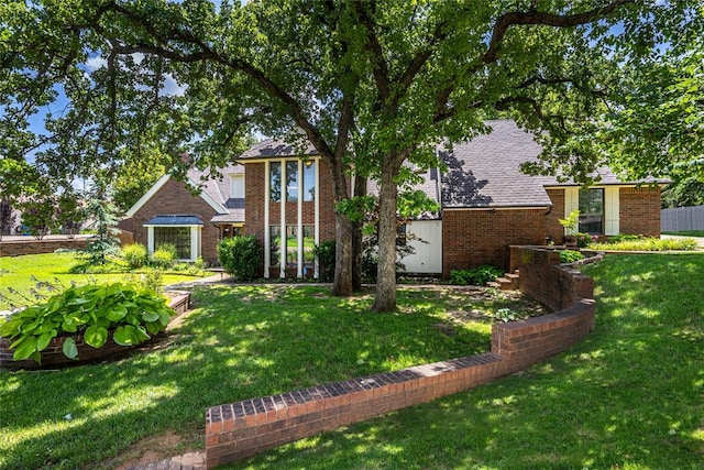 1504 Canary Pl, Edmond, OK 73034 - view of front of property with brick siding, a front yard, and roof with shingles