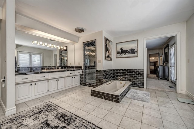 1504 Canary Pl, Edmond, OK 73034 - full bathroom featuring vanity, a shower stall, a garden tub, and tile patterned floors
