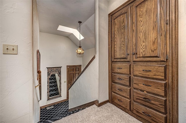 1504 Canary Pl, Edmond, OK 73034 - staircase featuring a skylight, carpet flooring, vaulted ceiling, and a textured wall