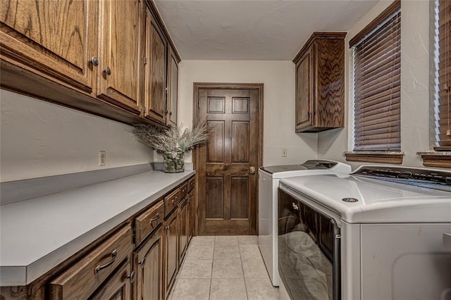1504 Canary Pl, Edmond, OK 73034 - laundry area featuring independent washer and dryer, cabinet space, and light tile patterned floors