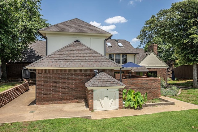 1504 Canary Pl, Edmond, OK 73034 - rear view of property with a chimney, brick siding, stucco siding, and a high end roof