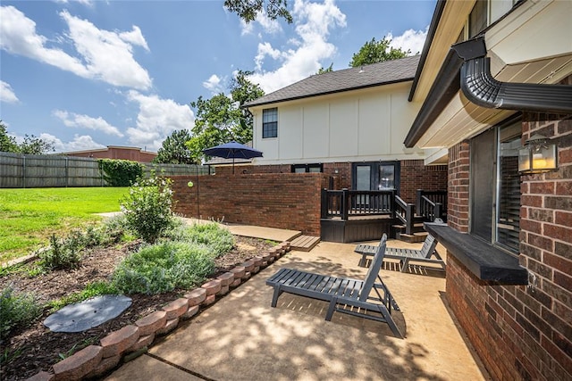 1504 Canary Pl, Edmond, OK 73034 - fenced backyard with a patio area and a wooden deck