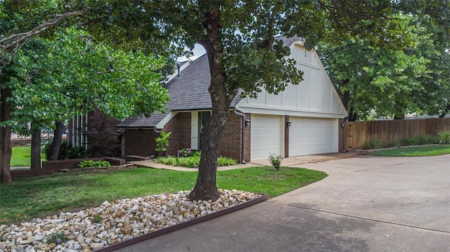 1504 Canary Pl, Edmond, OK 73034 - view of front of property with brick siding, an attached garage, driveway, and board and batten siding