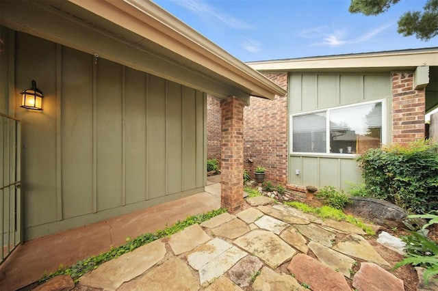4713 N Cypress Ct, Oklahoma City, OK 73162 - doorway to property with board and batten siding, a patio, and brick siding